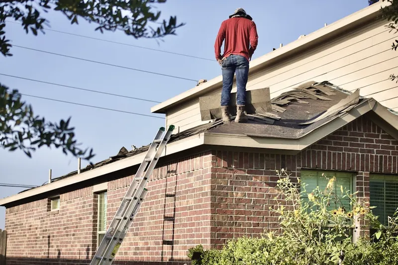 Professional roofer working on a residential roof in Weaverville